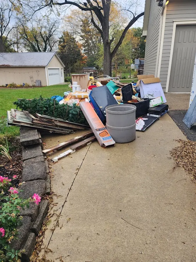 Dumpster being loaded with debris for Estate Cleanout Dumpster Rental in Steamboat Springs